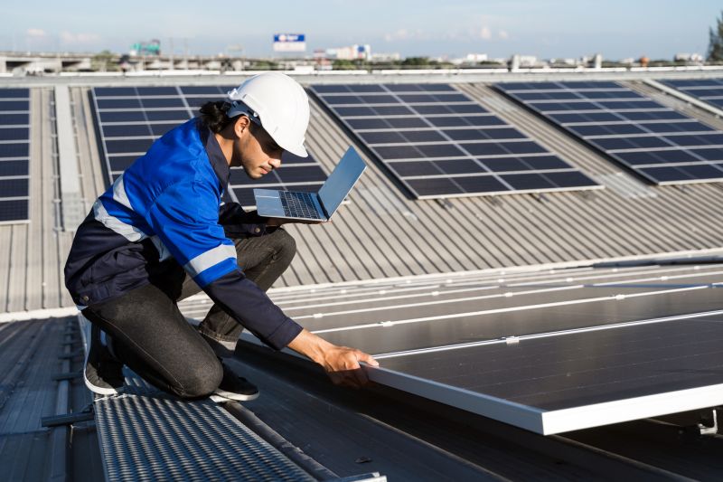 Technician repairing solar panels outdoors